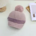 Detailed view of women's pink striped knitted hat with plush pom-pom and cozy winter design. - Adjustable / Light Pink