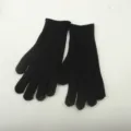 Close-up detail of black knitted gloves showing fine texture and warm winter material. - Solid Black