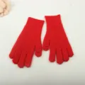 Detail view of winter red knitted open-hole gloves, soft and warm fashion accessory. - True Red