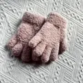 Close-up details of thick plush knit winter gloves in solid pink for kids cozy wear. - One Size / Pink