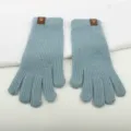 Detailed view of soft light blue knitted winter gloves with cute bear tag on wrist. - Light Blue Two-Finger Exposed Fingerless Gloves