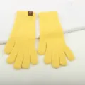 Detailed closeup view of soft yellow knit winter gloves showcasing the ribbed cuff design. - Yellow Two-Finger Exposed Fingerless Gloves