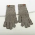 Detailed view of winter knitted gloves, ribbed texture and cute bear patch cuff design. - Grey Two-Finger Exposed Fingerless Gloves