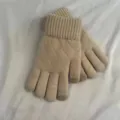 Close-up detail of women winter knit touchscreen gloves with diamond quilted pattern. - Off-White Double-Layer Argyle