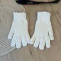 Detailed view of white knitted gloves featuring cute pink and green ruffled cuffs. - One Size / Pure White
