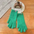 Close-up detail of winter warm knitted green gloves featuring cute bear patch decoration. - One Size / Solid Fingerless / Green