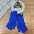 Detailed view of women's long knit winter gloves in vibrant blue with cute bear label accent. - One Size / Solid Fingerless / Blue