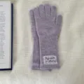 Detailed view of women's autumn winter long knit gloves in lavender with a delicate lace label. - One Size / Purple
