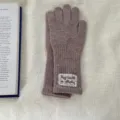 Detail view of women's warm knitted long gloves in taupe wool with lace wrist patch detail. - One Size / Coffee