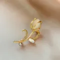 Elegant tulip brooch detailed close-up featuring sparkling rhinestones and a milky white stone for chic wear. - Tulip Brooch(975) / Gold