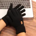 Close-up detail of black knit touch screen gloves, warm winter wear on laptop keyboard. - One Size / Black Label