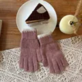 Detailed view of winter knit gloves in pink with cream ribbed cuffs, cozy lifestyle flat lay. - One Size / Peach