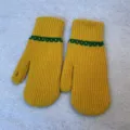 Close-up of cozy yellow winter knit mittens featuring green stripe pattern and warm design. - Full Coverage / Yellow