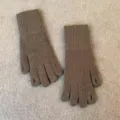Close-up detail shot of brown knit gloves with finger holes, warm winter thermal accessories. - Dark Gray