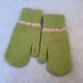 Green knit wool gloves close-up showing pink wave cuff detail and warm winter fingerless design. - Full Coverage / Green