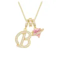 Close-up of gold necklace with zircon letter B and pink heart planet pendant detail. - Letter B (DXL-063) / Gold