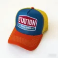 Classic American trucker hat with breathable mesh back, color blocking and embroidered patch. - Since1865-Blue + Orange Brim