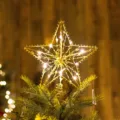 Golden iron wire star Christmas tree topper featuring warm LED fairy lights decoration - Gold Star Style