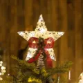 Glowing iron Christmas tree topper star with LED lights, red burlap bow, and pine cones - Bowknot Style