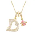 Detailed macro view of gold necklace with heart-shaped initial B and pink planet pendant - Letter D