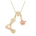 Detail view of gold-plated copper necklace with zirconia letter A and pink planet charm - Letter L