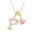 Detail of gold letter P necklace pendant with sparkling zircon and pink planet charm - Letter P