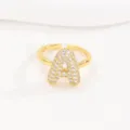 Close-up macro view of a gold-plated bubble letter A open ring with clear cubic zirconias - Letter A Style