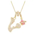 Detailed view of a gold necklace featuring a zircon-paved letter V and a pink planet charm. - Letter V