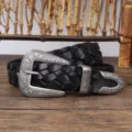 Close-up detail of vintage black woven leather belt with ornate silver floral buckle - 110cm / Black