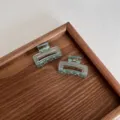 Two small 4cm square hair claw clips in translucent mint green displayed on a wooden tray - 2 Pieces/Pack / Transparent Blue