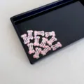 Adorable 2.5cm pink bone-shaped mini BB hair clips with colorful dots for kids and pets - Light Pink with Polka Dots