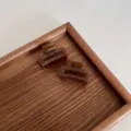 Set of two small 4cm rectangular amber hair claw clips displayed on a rustic wooden tray - 2 Pieces/Pack / Coffee