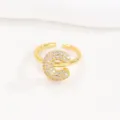 Detailed macro shot of a gold balloon bubble letter E ring encrusted with white stones - Letter C Style