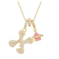Macro view of gold-plated box chain with letter X and pink planet stone pendants - Letter X