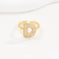 Close-up view of a gold bubble letter D open ring paved with cubic zirconia stones - Letter D Style