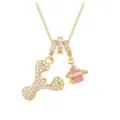 Close-up detail of the gold-plated letter Y pendant paired with a pink zircon Saturn charm - Letter Y