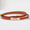 Vrouwen dunne oranje lederen riem met gouden draaibare gesp elegante stijl voor jurk chic. - camel