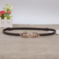 Slim brown leather belt featuring a delicate gold leaf pearl buckle detail for waist shaping. - Coffee