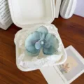 Elegant blue-green orchid flower hair clip with pearl center in aesthetic packaging detail - Lake Blue