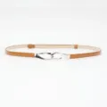 Skinny patent leather belt in brown with a sleek silver metal hook buckle for stylish waist definition. - Camel