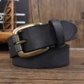 Close-up of vintage top grain cowhide men's belt with textured bronze buckle - Black