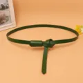 Detailed view of a dark green thin cowhide leather belt for women's dress decoration - Green