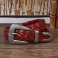 Close-up detail of a vintage reddish-brown woven leather belt with ornate silver buckle - 110cm / Red Brown
