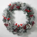Detailed view of flocked pine Christmas wreath with red cardinal birds and berries - 55cm