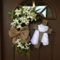 Detailed view of a religious Easter wreath with white lilies and a wooden cross - Cross Wreath (White Scarf) / 40CM