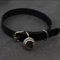 Closeup of black leather choker collar with metal bell detail, punk harajuku style accessory. - Single Collar / Flat Bell Choker (Black)