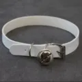 Close-up shot of a white PU leather choker necklace featuring a cute metal bell and buckle. - Flat Bell Choker (White)