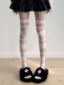 Detail shot of white bandage over-the-knee socks, unique Y2K subculture leg wear style. - 1 Pair / White