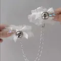 White lace bell bracelet cuffs with metal chain accessory, delicate and charming design. - White Bow Handcuffs