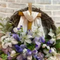 Detailed close-up of Easter wreath featuring wooden cross with white lilies and tulips - 45cm / Cross Wreath (White Scarf)